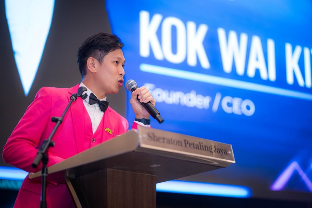 Baterihub Founder and CEO Kok Wai Kiat speaking passionately at an event, addressing the audience from the stage.