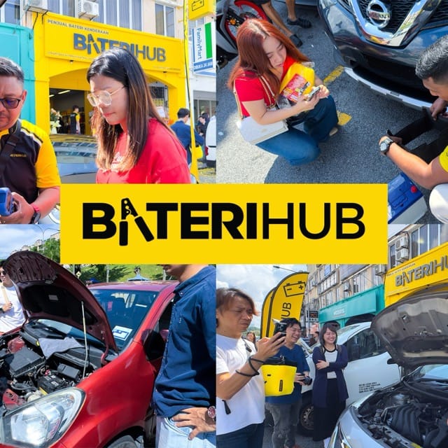 Baterihub Ground Car Battery Check & Customer Engagement Event Baterihub team conducting car battery checks and engaging with customers during an outdoor promotional event in front of their yellow storefront.