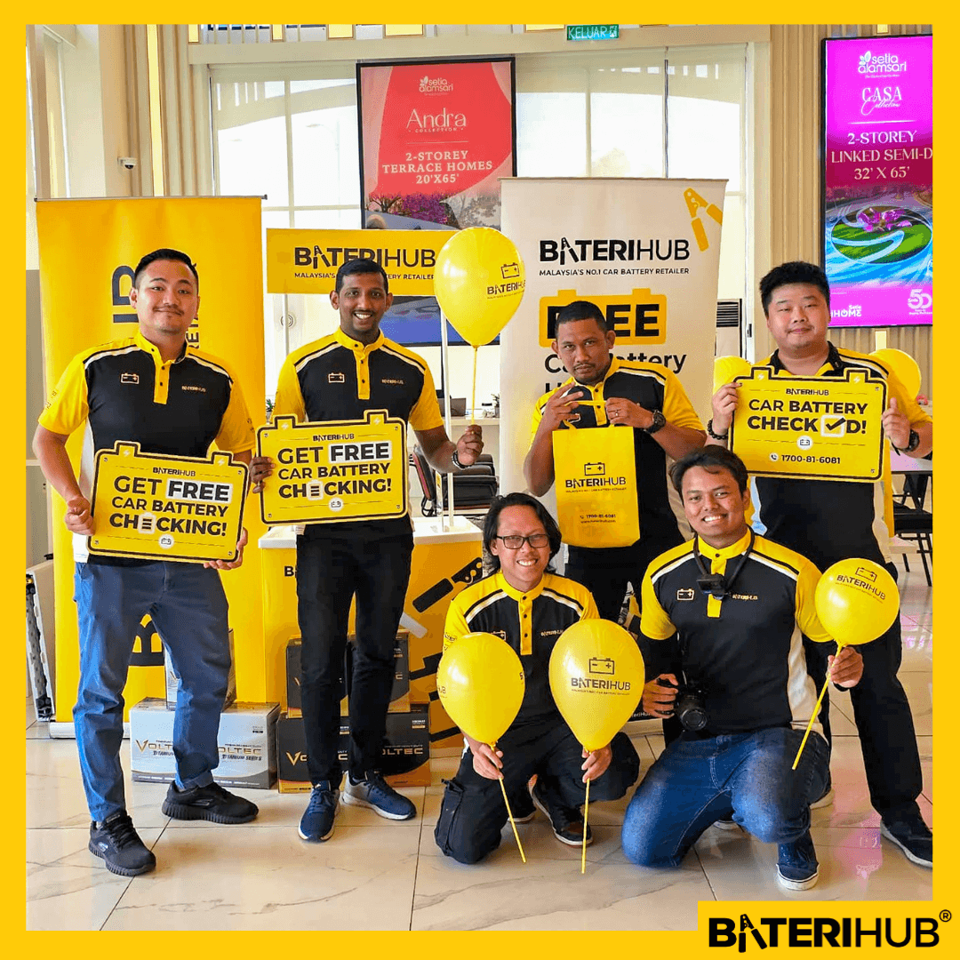 Alam Sari Blog Cover BateriHub team promoting free car battery health check event with branded signage and balloons at indoor corporate event in Malaysia.