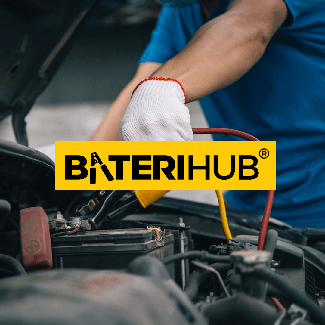 Car Battery Failure in Malaysia’s Climate BateriHub technician installing car battery with jumper cables under car hood in Malaysia