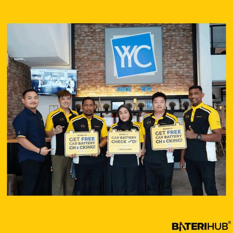 YYC Battery Checking BateriHub team posing at YYC office holding “Free Car Battery Checking” signs during corporate battery health check event.