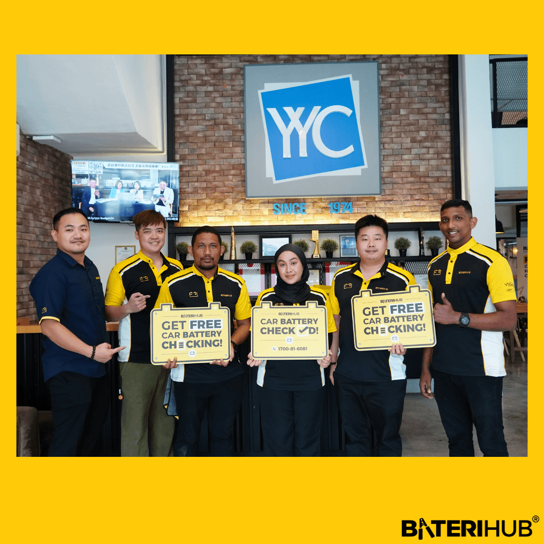 YYC Battery Checking BateriHub team posing at YYC office holding “Free Car Battery Checking” signs during corporate battery health check event.