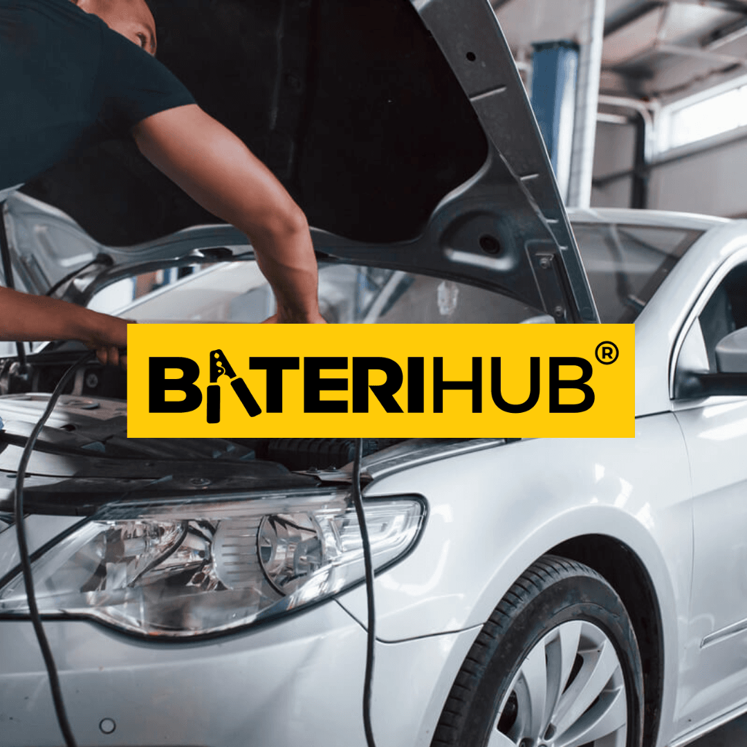 honda-city-battery-replacement-service A professional technician performing a Honda City battery replacement and checking engine terminals in a workshop.